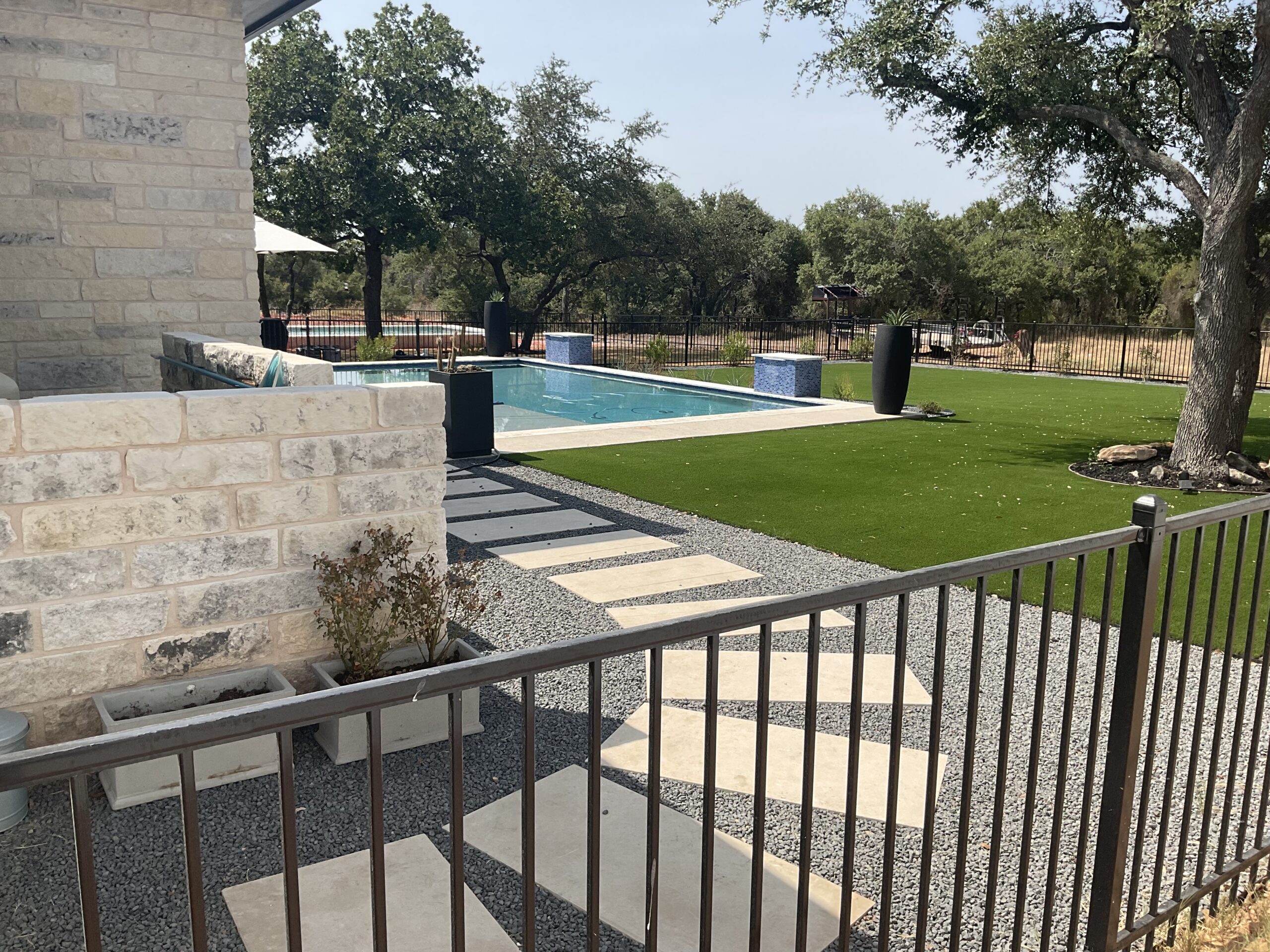 Ornamental steel fence surrounding a residential pool area installation
