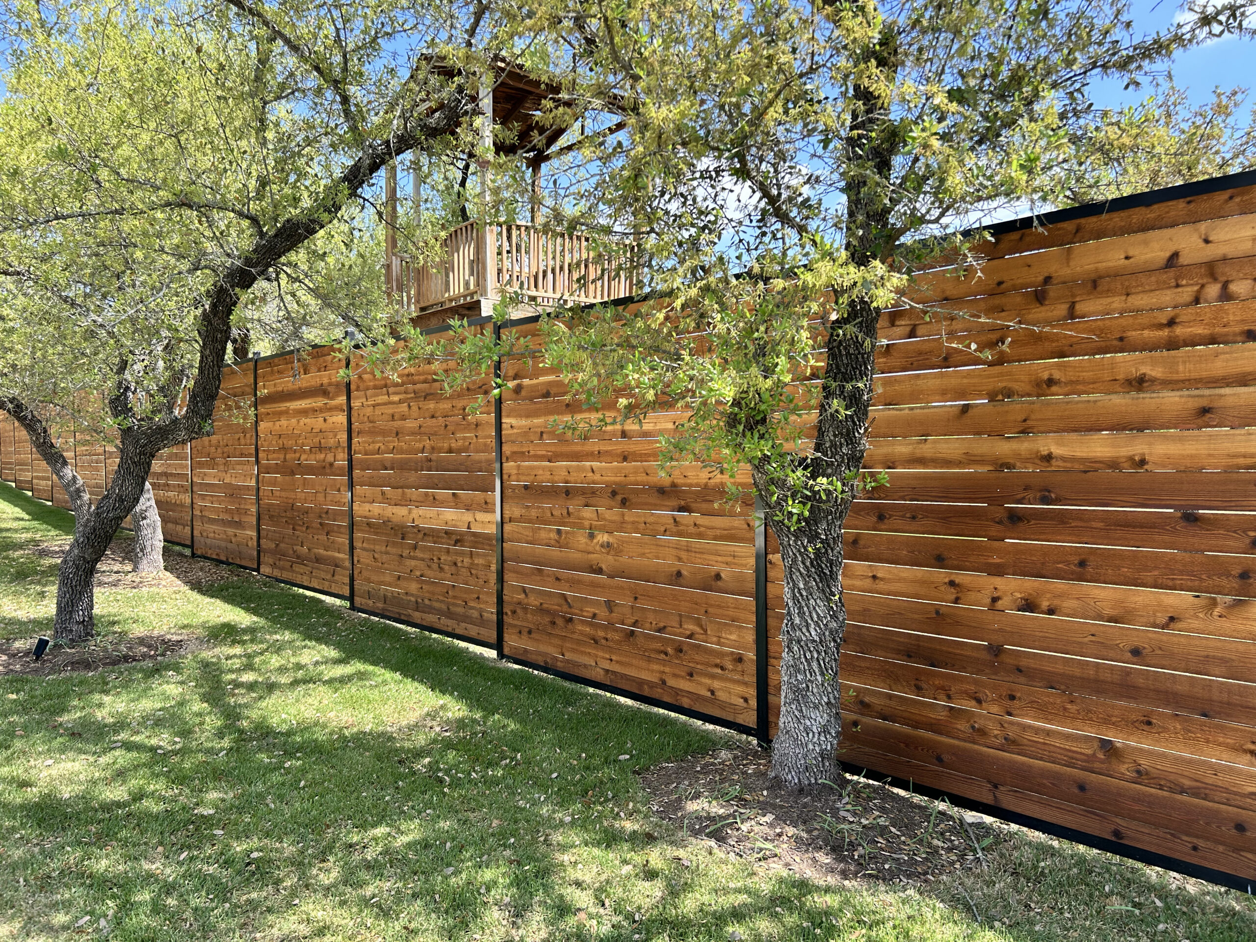 Modern horizontal cedar privacy fence professionally installed by Hicks Fencing.